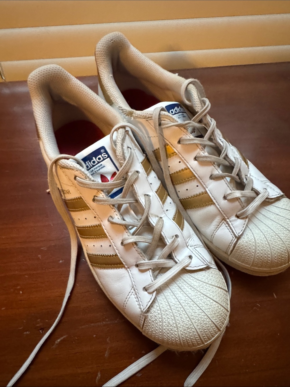 adidas White Leather Sneakers with Gold Stripe Accents